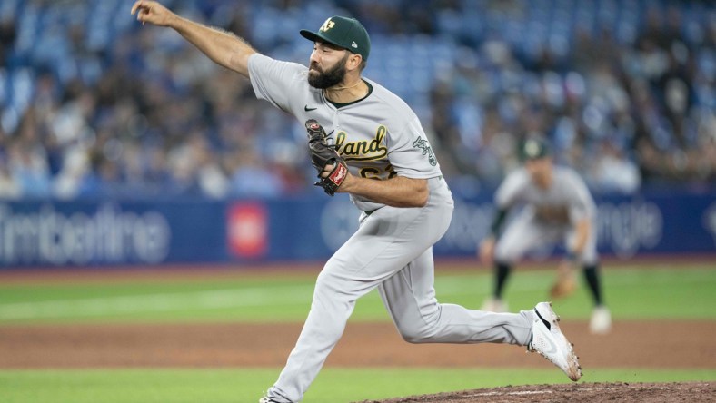 Apr 16, 2022; Toronto, Ontario, CAN; Oakland Athletics relief pitcher Lou Trivino (62) throws a pitch during the ninth inning against the Toronto Blue Jays at Rogers Centre. Mandatory Credit: Nick Turchiaro-USA TODAY Sports