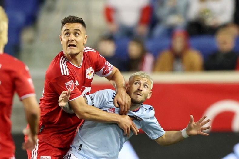 Apr 16, 2022; Harrison, New Jersey, USA; New York Red Bulls midfielder Aaron Long (33) and FC Dallas forward Paul Arriola (7) battle for position in the second half of their game at Red Bull Arena. Mandatory Credit: Vincent Carchietta-USA TODAY Sports
