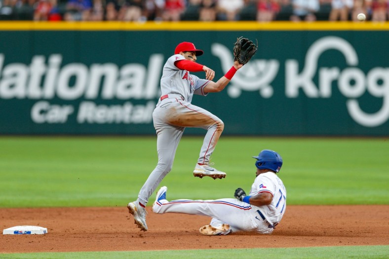 Apr 16, 2022; Arlington, Texas, USA; Texas Rangers third baseman Andy Ibanez (77) slides in under Los Angeles Angels second baseman Tyler Wade (14) during the third inning at Globe Life Field. Mandatory Credit: Andrew Dieb-USA TODAY Sports