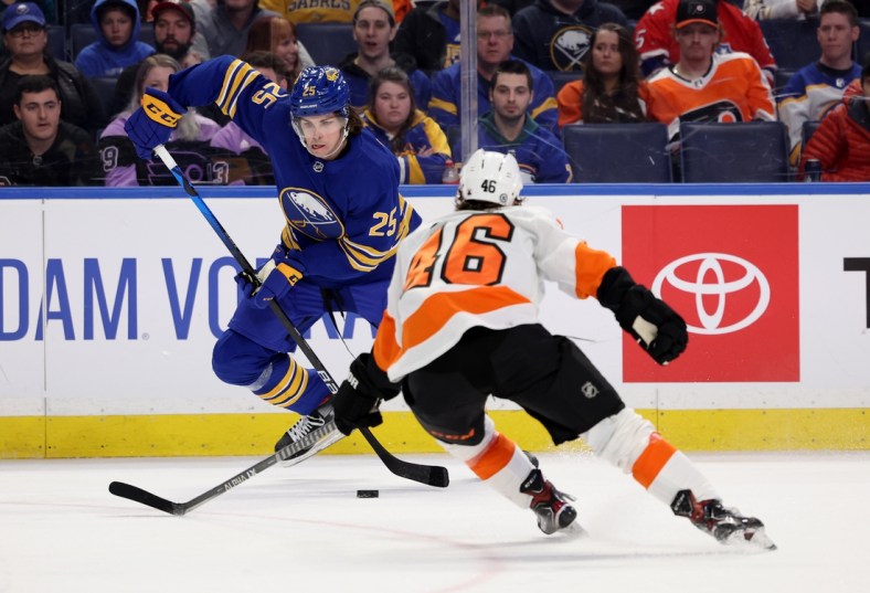 Apr 16, 2022; Buffalo, New York, USA;  Buffalo Sabres defenseman Owen Power (25) skates with the puck as Philadelphia Flyers right wing Bobby Brink (46) defends during the second period at KeyBank Center. Mandatory Credit: Timothy T. Ludwig-USA TODAY Sports