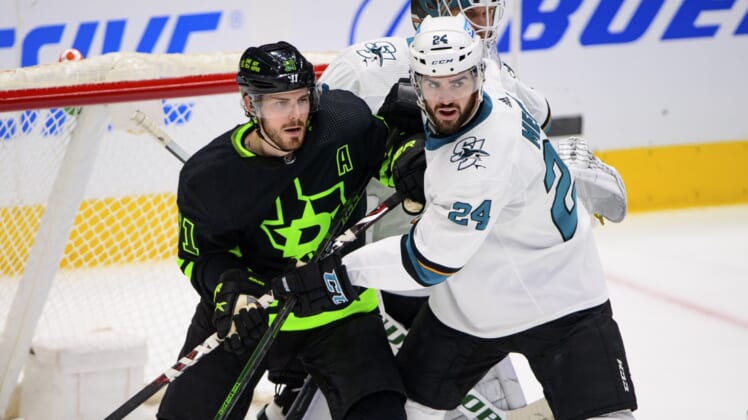 Apr 16, 2022; Dallas, Texas, USA; San Jose Sharks defenseman Jaycob Megna (24) defends against Dallas Stars center Tyler Seguin (91) during the first period at the American Airlines Center. Mandatory Credit: Jerome Miron-USA TODAY Sports