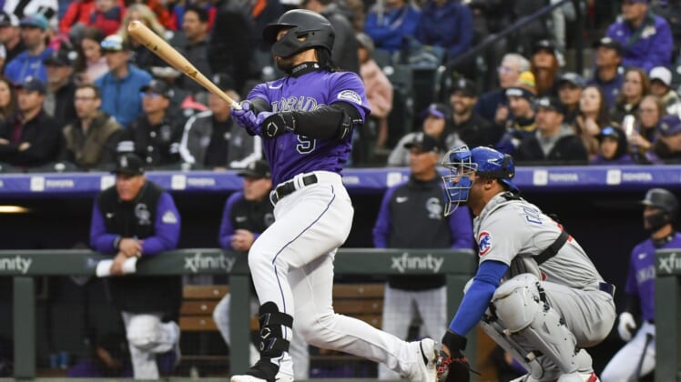 Apr 16, 2022; Denver, Colorado, USA;  Colorado Rockies first baseman Connor Joe (9) triples to center field to drive in Colorado Rockies catcher Dom Nunez (3) during the third inning against the Chicago Cubs at Coors Field. Mandatory Credit: John Leyba-USA TODAY Sports