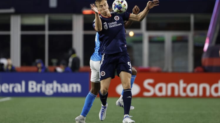 Apr 16, 2022; Foxborough, Massachusetts, USA; New England Revolution forward Adam Buksa (9) tries to control the ball in front of Charlotte FC defender Christian Makoun (14) during the second half at Gillette Stadium. Mandatory Credit: Winslow Townson-USA TODAY Sports