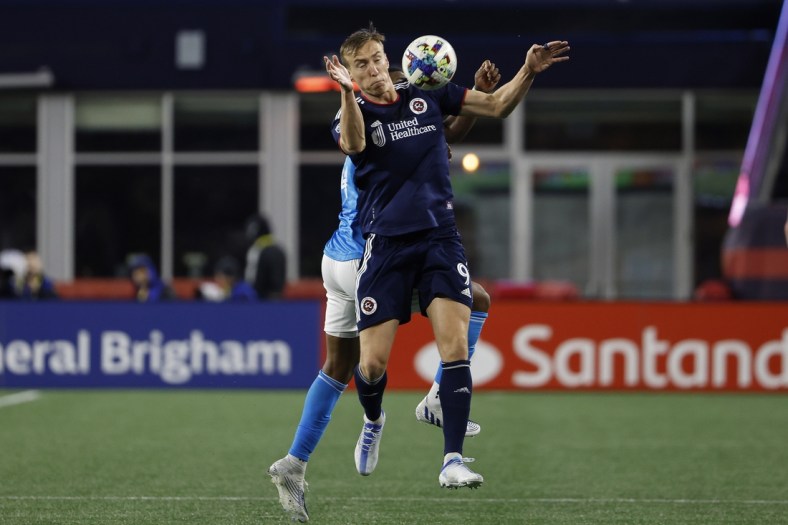 Apr 16, 2022; Foxborough, Massachusetts, USA; New England Revolution forward Adam Buksa (9) tries to control the ball in front of Charlotte FC defender Christian Makoun (14) during the second half at Gillette Stadium. Mandatory Credit: Winslow Townson-USA TODAY Sports
