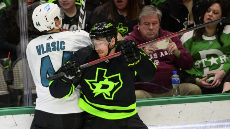 Apr 16, 2022; Dallas, Texas, USA; Dallas Stars left wing Michael Raffl (18) checks San Jose Sharks defenseman Marc-Edouard Vlasic (44) during the second period at the American Airlines Center. Mandatory Credit: Jerome Miron-USA TODAY Sports