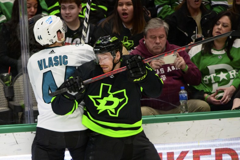 Apr 16, 2022; Dallas, Texas, USA; Dallas Stars left wing Michael Raffl (18) checks San Jose Sharks defenseman Marc-Edouard Vlasic (44) during the second period at the American Airlines Center. Mandatory Credit: Jerome Miron-USA TODAY Sports