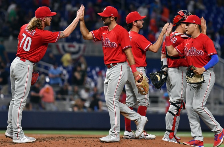 Apr 16, 2022; Miami, Florida, USA; Philadelphia Phillies relief pitcher Bailey Falter (70) and center fielder Matt Vierling (19) celebrate a 10-3 win over the Miami Marlins at loanDepot Park. Mandatory Credit: Jim Rassol-USA TODAY Sports