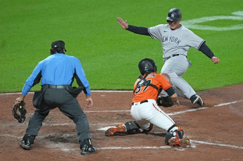 Apr 16, 2022; Baltimore, Maryland, USA; New York Yankees first baseman Anthony Rizzo (48) is tagged out by Baltimore Orioles catcher Anthony Benboom (37) in the fifth inning at Oriole Park at Camden Yards. Mandatory Credit: Mitch Stringer-USA TODAY Sports