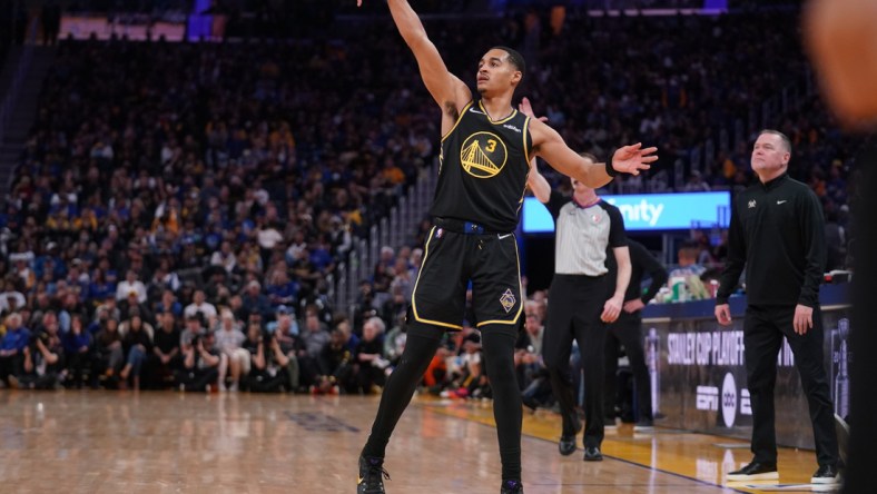 Apr 16, 2022; San Francisco, California, USA; Golden State Warriors guard Jordan Poole (3) follows through on a shot after making a three point basket against the Denver Nuggets in the fourth quarter during game one of the first round for the 2022 NBA playoffs at the Chase Center. Mandatory Credit: Cary Edmondson-USA TODAY Sports