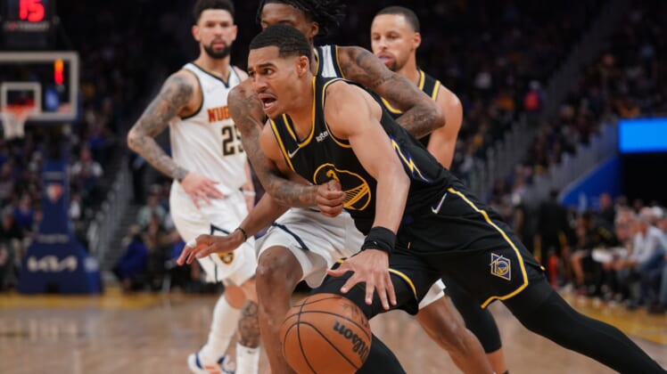 Apr 16, 2022; San Francisco, California, USA; Golden State Warriors guard Jordan Poole (3) dribbles against Denver Nuggets guard Bones Hyland (3) in the fourth quarter during game one of the first round for the 2022 NBA playoffs at the Chase Center. Mandatory Credit: Cary Edmondson-USA TODAY Sports