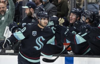 Apr 16, 2022; Seattle, Washington, USA; Seattle Kraken forward Matty Beniers (10) is congratulated by teammates on the bench after scoring his first NHL during the second period against the New Jersey Devils at Climate Pledge Arena. Mandatory Credit: Stephen Brashear-USA TODAY Sports