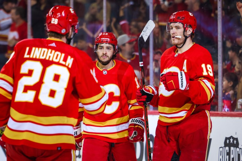 Apr 16, 2022; Calgary, Alberta, CAN; Calgary Flames left wing Matthew Tkachuk (19) celebrates his goal with teammates against the Arizona Coyotes during the third period at Scotiabank Saddledome. Mandatory Credit: Sergei Belski-USA TODAY Sports