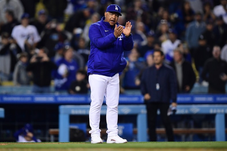 Apr 16, 2022; Los Angeles, California, USA; Los Angeles Dodgers manager Dave Roberts (30) celebrates the victory against the Cincinnati Reds at Dodger Stadium. Mandatory Credit: Gary A. Vasquez-USA TODAY Sports