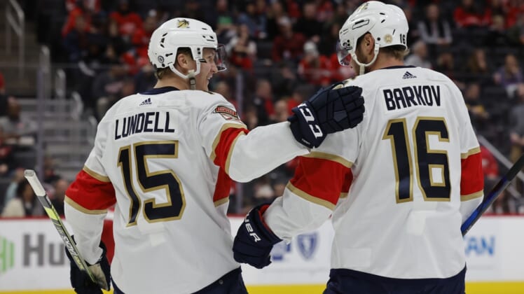 Apr 17, 2022; Detroit, Michigan, USA; Florida Panthers center Anton Lundell (15) receives congratulations from center Aleksander Barkov (16) after scoring in the third period against the Detroit Red Wings at Little Caesars Arena. Mandatory Credit: Rick Osentoski-USA TODAY Sports