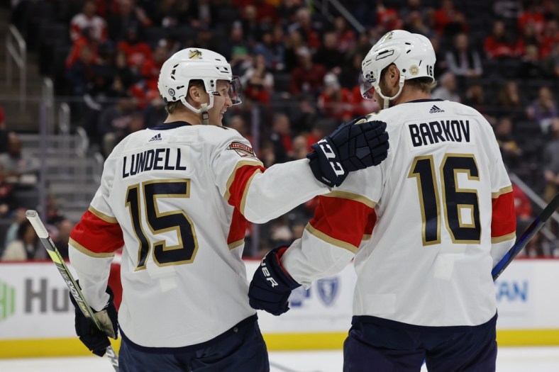 Apr 17, 2022; Detroit, Michigan, USA; Florida Panthers center Anton Lundell (15) receives congratulations from center Aleksander Barkov (16) after scoring in the third period against the Detroit Red Wings at Little Caesars Arena. Mandatory Credit: Rick Osentoski-USA TODAY Sports