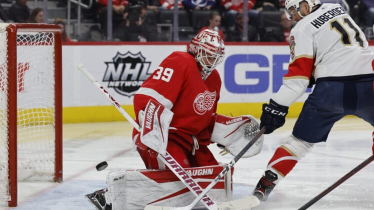 Apr 17, 2022; Detroit, Michigan, USA; Detroit Red Wings goaltender Alex Nedeljkovic (39) makes a save on Florida Panthers left wing Jonathan Huberdeau (11) in the third period at Little Caesars Arena. Mandatory Credit: Rick Osentoski-USA TODAY Sports