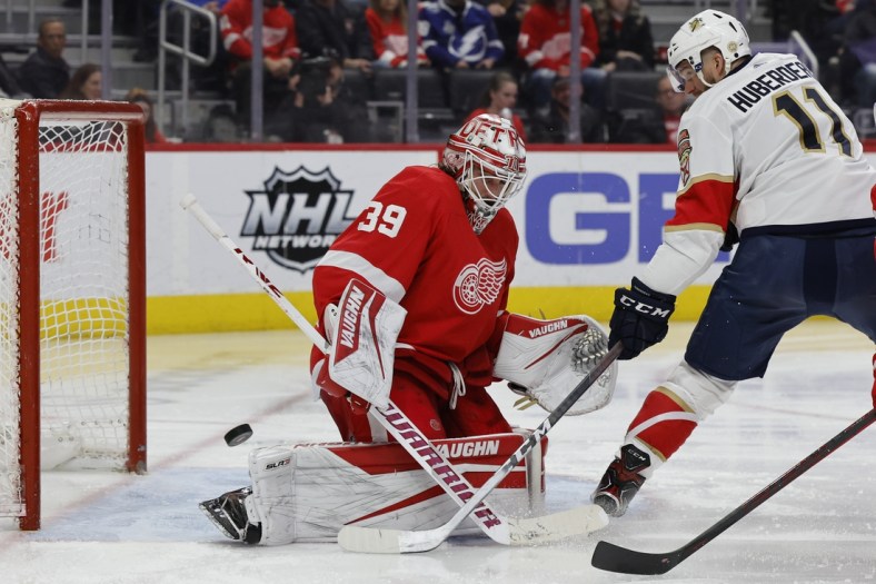 Apr 17, 2022; Detroit, Michigan, USA; Detroit Red Wings goaltender Alex Nedeljkovic (39) makes a save on Florida Panthers left wing Jonathan Huberdeau (11) in the third period at Little Caesars Arena. Mandatory Credit: Rick Osentoski-USA TODAY Sports