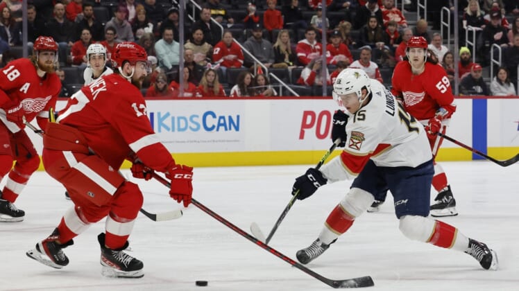 Apr 17, 2022; Detroit, Michigan, USA; Florida Panthers center Anton Lundell (15) takes a shot defended by Detroit Red Wings defenseman Filip Hronek (17) in the third period at Little Caesars Arena. Mandatory Credit: Rick Osentoski-USA TODAY Sports