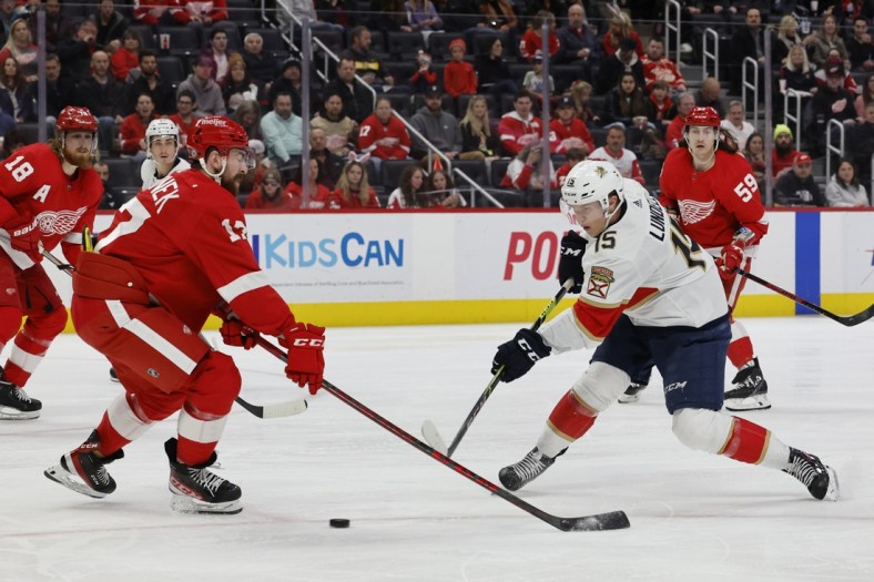 Apr 17, 2022; Detroit, Michigan, USA; Florida Panthers center Anton Lundell (15) takes a shot defended by Detroit Red Wings defenseman Filip Hronek (17) in the third period at Little Caesars Arena. Mandatory Credit: Rick Osentoski-USA TODAY Sports