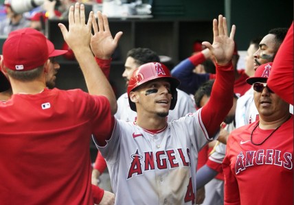 Apr 17, 2022; Arlington, Texas, USA; Los Angeles Angels shortstop Andrew Velazquez (4) is greeted in the dugout after scoring during the sixth inning against the Texas Rangers at Globe Life Field. Mandatory Credit: Raymond Carlin III-USA TODAY Sports