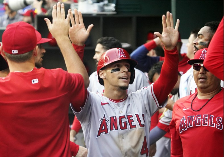 Apr 17, 2022; Arlington, Texas, USA; Los Angeles Angels shortstop Andrew Velazquez (4) is greeted in the dugout after scoring during the sixth inning against the Texas Rangers at Globe Life Field. Mandatory Credit: Raymond Carlin III-USA TODAY Sports