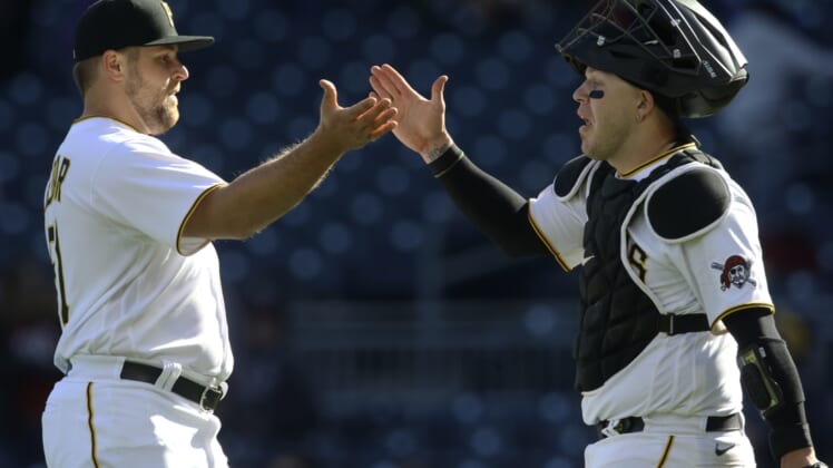 Apr 17, 2022; Pittsburgh, Pennsylvania, USA;  Pittsburgh Pirates relief pitcher David Bednar (51) and catcher Roberto Perez (55) celebrate after defeating the Washington Nationals at PNC Park. The Pirates won 5-3. Mandatory Credit: Charles LeClaire-USA TODAY Sports