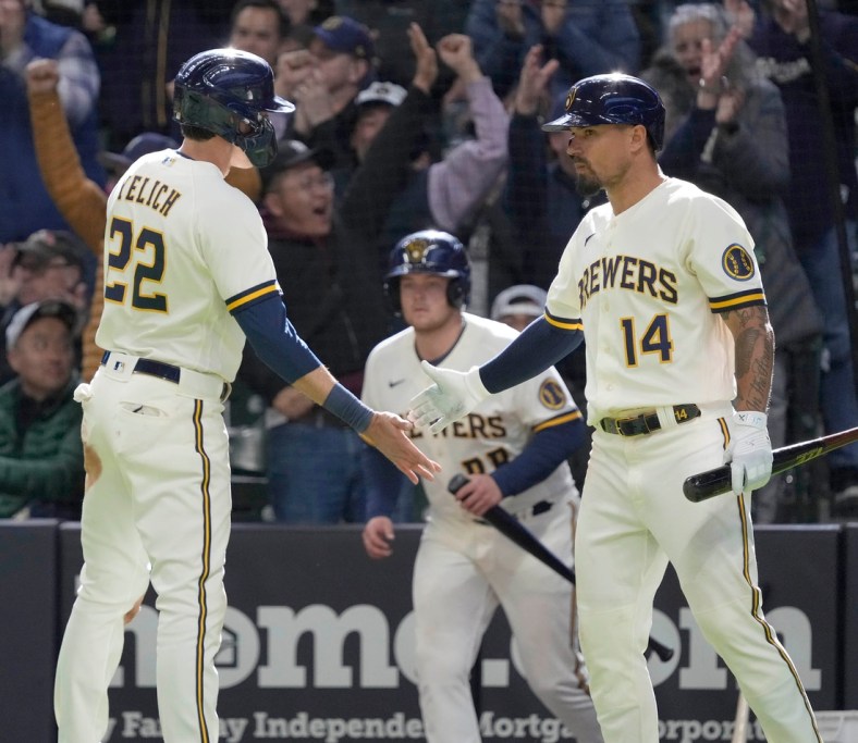 Milwaukee Brewers left fielder Christian Yelich (22) celebrates with second baseman Jace Peterson (14) after scoring on a Tyrone Taylor double during the seventh inning of their game against the St. Louis Cardinals at American Family Field in Milwaukee on Sunday, April 17, 2022. Photo by Mike De Sisti / The Milwaukee Journal Sentinel

Brewers Brewers18 3479