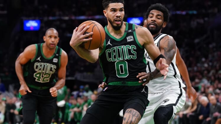 Apr 17, 2022; Boston, Massachusetts, USA; Boston Celtics forward Jayson Tatum (0) drives the ball against Brooklyn Nets guard Kyrie Irving (11) in the second half during game one of the first round for the 2022 NBA playoffs at TD Garden. Mandatory Credit: David Butler II-USA TODAY Sports