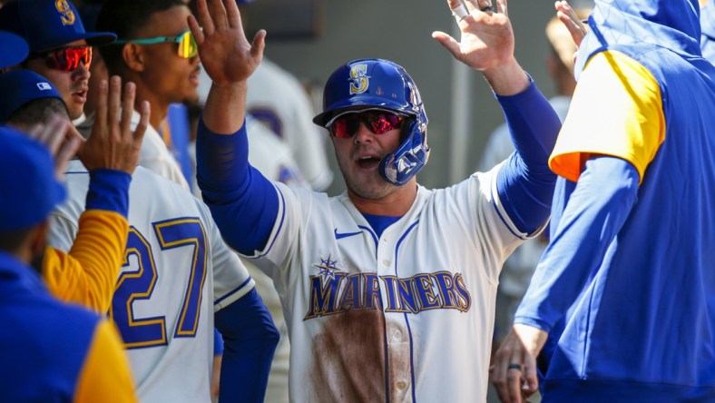 Apr 17, 2022; Seattle, Washington, USA; Seattle Mariners first baseman Ty France (23) celebrates in the dugout after scoring a run against the Houston Astros during the first inning at T-Mobile Park. Mandatory Credit: Joe Nicholson-USA TODAY Sports