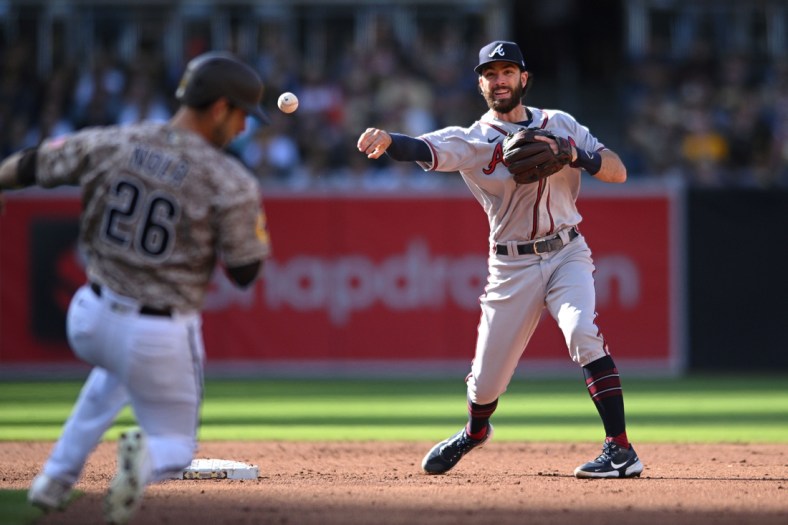 Apr 17, 2022; San Diego, California, USA; Atlanta Braves shortstop Dansby Swanson (right) throws to first base late after forcing out San Diego Padres catcher Austin Nola (26) at second base during the second inning at Petco Park. Mandatory Credit: Orlando Ramirez-USA TODAY Sports