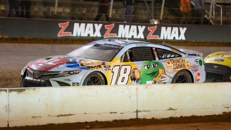 Apr 17, 2022; Bristol, Tennessee, USA; NASCAR Cup Series driver Kyle Busch (18) during a red flag at the Bristol Motor Speedway Dirt Course. Mandatory Credit: Randy Sartin-USA TODAY Sports