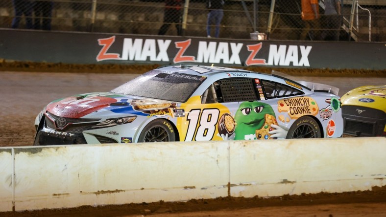 Apr 17, 2022; Bristol, Tennessee, USA; NASCAR Cup Series driver Kyle Busch (18) during a red flag at the Bristol Motor Speedway Dirt Course. Mandatory Credit: Randy Sartin-USA TODAY Sports