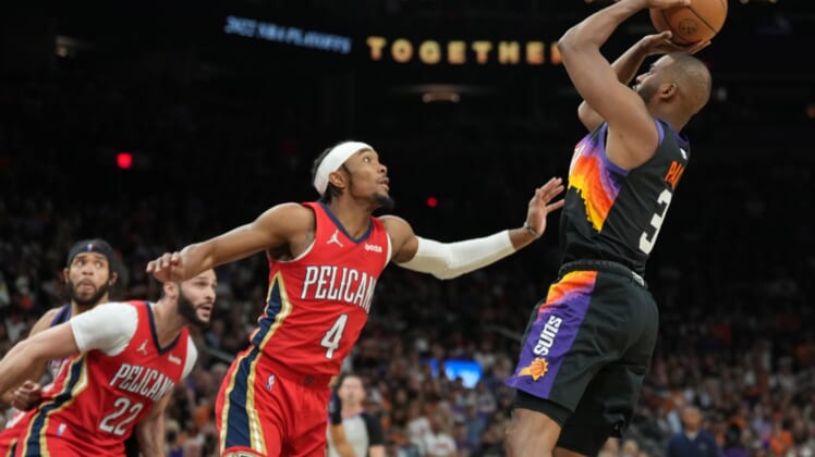 Apr 17, 2022; Phoenix, Arizona, USA; Phoenix Suns guard Chris Paul (3) shoots over New Orleans Pelicans guard Devonte' Graham (4) during the second half of game one of the first round for the 2022 NBA playoffs at Footprint Center. Mandatory Credit: Joe Camporeale-USA TODAY Sports