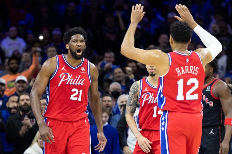 Apr 18, 2022; Philadelphia, Pennsylvania, USA; Philadelphia 76ers center Joel Embiid (21) reacts with forward Tobias Harris (12) after a score and one against the Toronto Raptors during the first quarter in game two of the first round for the 2022 NBA playoffs at Wells Fargo Center. Mandatory Credit: Bill Streicher-USA TODAY Sports