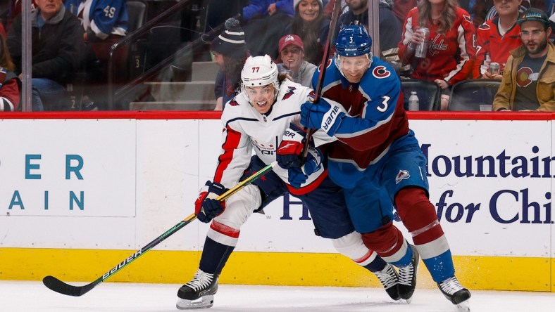 Apr 18, 2022; Denver, Colorado, USA; Washington Capitals right wing T.J. Oshie (77) and Colorado Avalanche defenseman Jack Johnson (3) battle for the puck in the first period at Ball Arena. Mandatory Credit: Isaiah J. Downing-USA TODAY Sports