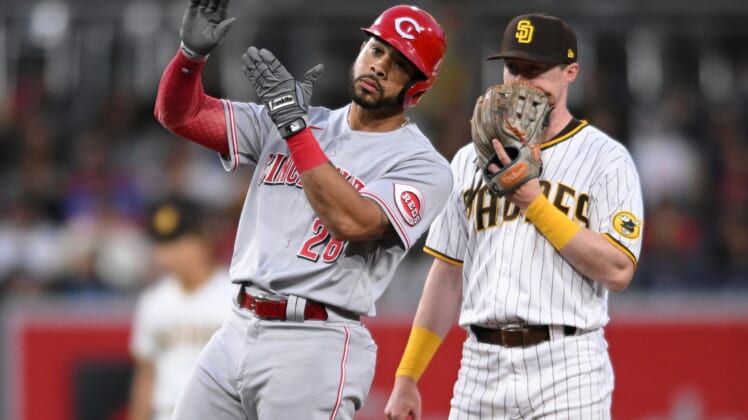 Apr 18, 2022; San Diego, California, USA; Cincinnati Reds designated hitter Tommy Pham (28) reacts after hitting a double as San Diego Padres second baseman hitter Jake Cronenworth (right) looks on during the third inning at Petco Park. Mandatory Credit: Orlando Ramirez-USA TODAY Sports