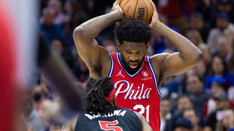 Apr 18, 2022; Philadelphia, Pennsylvania, USA; Philadelphia 76ers center Joel Embiid (21) controls the ball against Toronto Raptors forward Precious Achiuwa (5) during the third quarter in game two of the first round for the 2022 NBA playoffs at Wells Fargo Center. Mandatory Credit: Bill Streicher-USA TODAY Sports