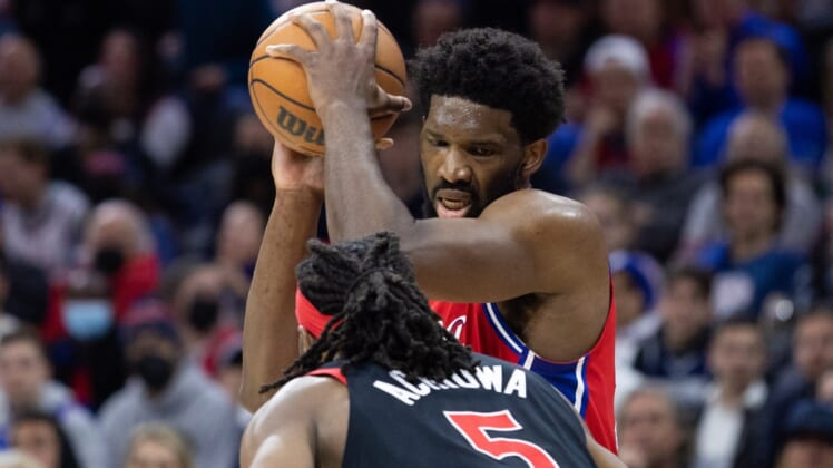 Apr 18, 2022; Philadelphia, Pennsylvania, USA; Philadelphia 76ers center Joel Embiid (21) controls the ball against Toronto Raptors forward Precious Achiuwa (5) during the third quarter in game two of the first round for the 2022 NBA playoffs at Wells Fargo Center. Mandatory Credit: Bill Streicher-USA TODAY Sports