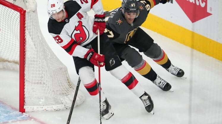 Apr 18, 2022; Las Vegas, Nevada, USA; Vegas Golden Knights left wing Max Pacioretty (67) looks to tip the puck away from New Jersey Devils defenseman Damon Severson (28) during the first period at T-Mobile Arena. Mandatory Credit: Stephen R. Sylvanie-USA TODAY Sports
