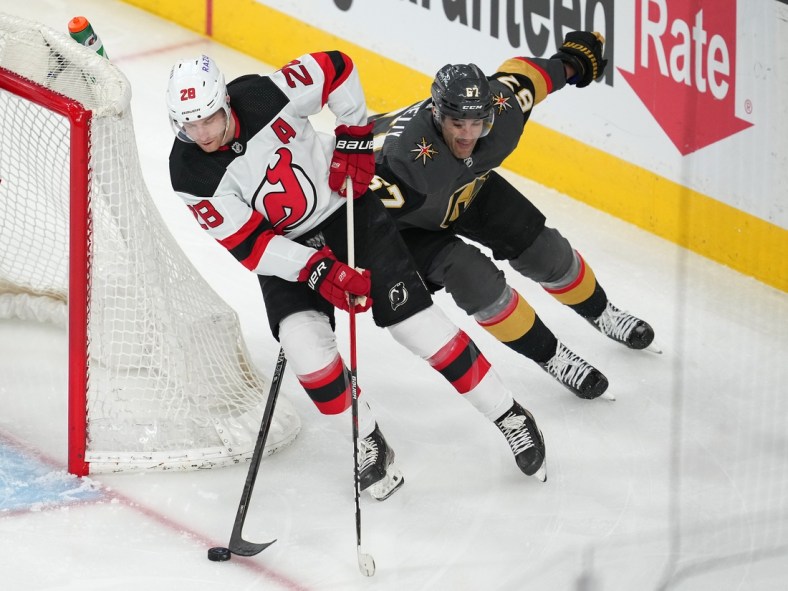 Apr 18, 2022; Las Vegas, Nevada, USA; Vegas Golden Knights left wing Max Pacioretty (67) looks to tip the puck away from New Jersey Devils defenseman Damon Severson (28) during the first period at T-Mobile Arena. Mandatory Credit: Stephen R. Sylvanie-USA TODAY Sports