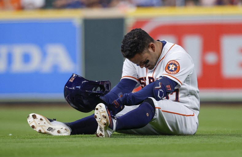 Apr 18, 2022; Houston, Texas, USA; Houston Astros second baseman Jose Altuve (27) reacts after an apparent injury during the eighth inning against the Los Angeles Angels at Minute Maid Park. Mandatory Credit: Troy Taormina-USA TODAY Sports