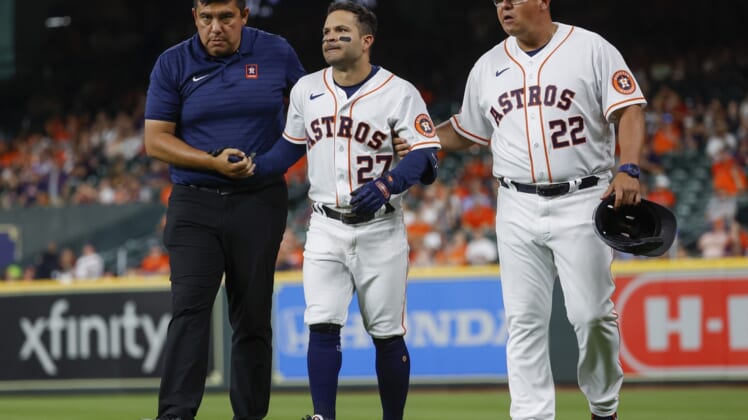 Apr 18, 2022; Houston, Texas, USA; Houston Astros second baseman Jose Altuve (27) is assisted off the field after an apparent injury during the eighth inning against the Los Angeles Angels at Minute Maid Park. Mandatory Credit: Troy Taormina-USA TODAY Sports