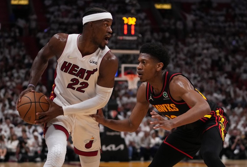 Apr 19, 2022; Miami, Florida, USA; Miami Heat forward Jimmy Butler (22) controls the ball around Atlanta Hawks forward De'Andre Hunter (12) during the first half in game two of the first round for the 2022 NBA playoffs at FTX Arena. Mandatory Credit: Jasen Vinlove-USA TODAY Sports