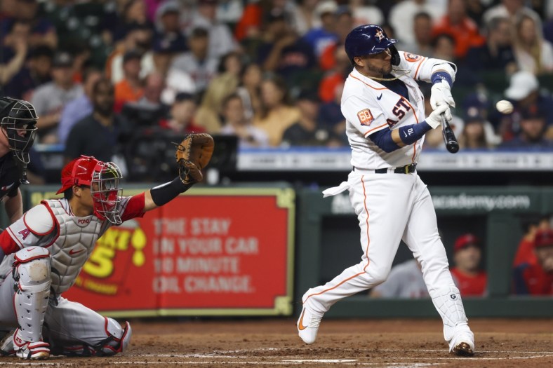 Apr 19, 2022; Houston, Texas, USA; Houston Astros first baseman Yuli Gurriel (10) hits a double against the Los Angeles Angels in the second inning at Minute Maid Park. Mandatory Credit: Thomas Shea-USA TODAY Sports