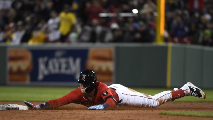 Apr 19, 2022; Boston, Massachusetts, USA;  Boston Red Sox second baseman Trevor Story (10) slides into second base after hitting an RBI double during the third inning against the Toronto Blue Jays at Fenway Park. Mandatory Credit: Bob DeChiara-USA TODAY Sports
