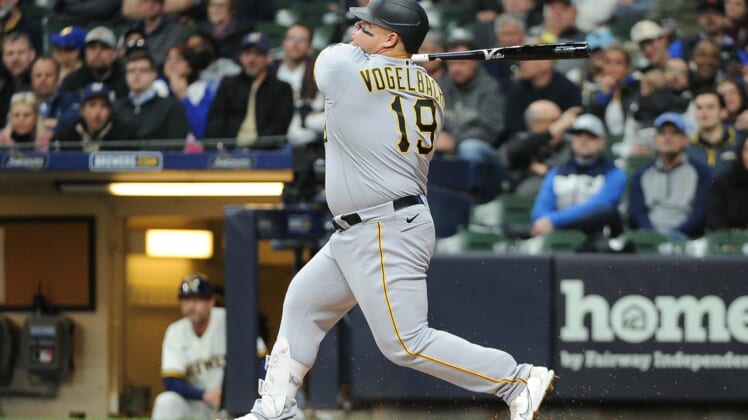 Apr 19, 2022; Milwaukee, Wisconsin, USA;  Pittsburgh Pirates first baseman Daniel Vogelbach (19) hits a home run in the sixth inning against the Milwaukee Brewers at American Family Field. Mandatory Credit: Michael McLoone-USA TODAY Sports
