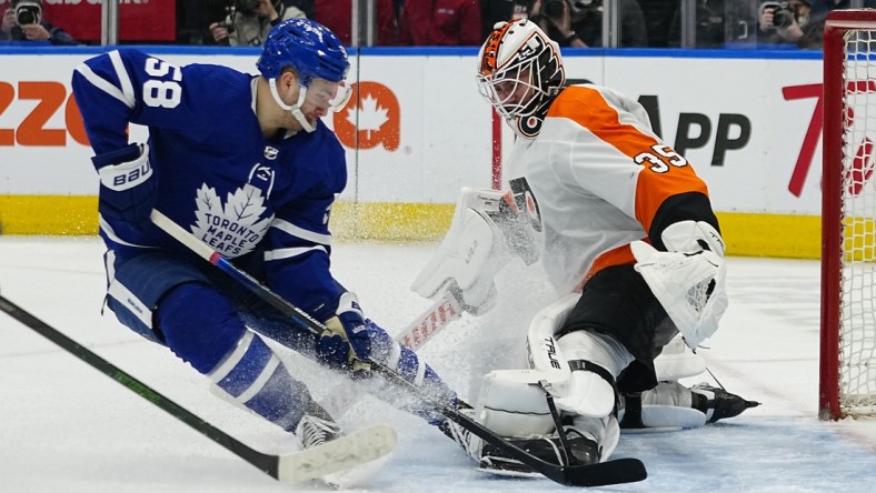 Apr 19, 2022; Toronto, Ontario, CAN; Philadelphia Flyers goaltender Martin Jones (35) makes a save on Toronto Maple Leafs forward Michael Bunting (58) during the third period at Scotiabank Arena. Mandatory Credit: John E. Sokolowski-USA TODAY Sports