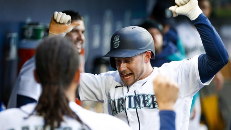 Apr 19, 2022; Seattle, Washington, USA; Seattle Mariners right fielder Jarred Kelenic (10) celebrates in the dugout after hitting a solo-home run against the Texas Rangers during the second inning at T-Mobile Park. Mandatory Credit: Joe Nicholson-USA TODAY Sports
