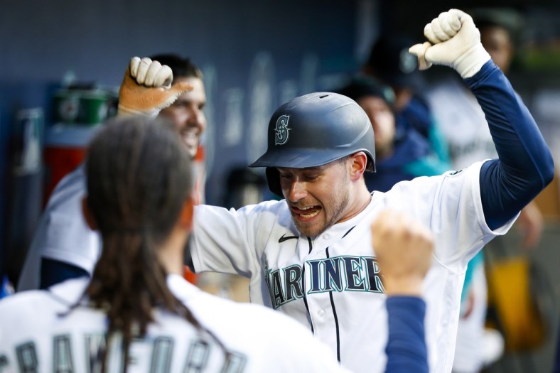 Apr 19, 2022; Seattle, Washington, USA; Seattle Mariners right fielder Jarred Kelenic (10) celebrates in the dugout after hitting a solo-home run against the Texas Rangers during the second inning at T-Mobile Park. Mandatory Credit: Joe Nicholson-USA TODAY Sports