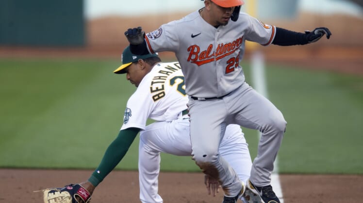 Apr 19, 2022; Oakland, California, USA; Baltimore Orioles second baseman Ramon Urias (29) runs back to first base to avoid a double play by Oakland Athletics first baseman Christian Bethancourt (23) during the second inning at RingCentral Coliseum. Mandatory Credit: D. Ross Cameron-USA TODAY Sports